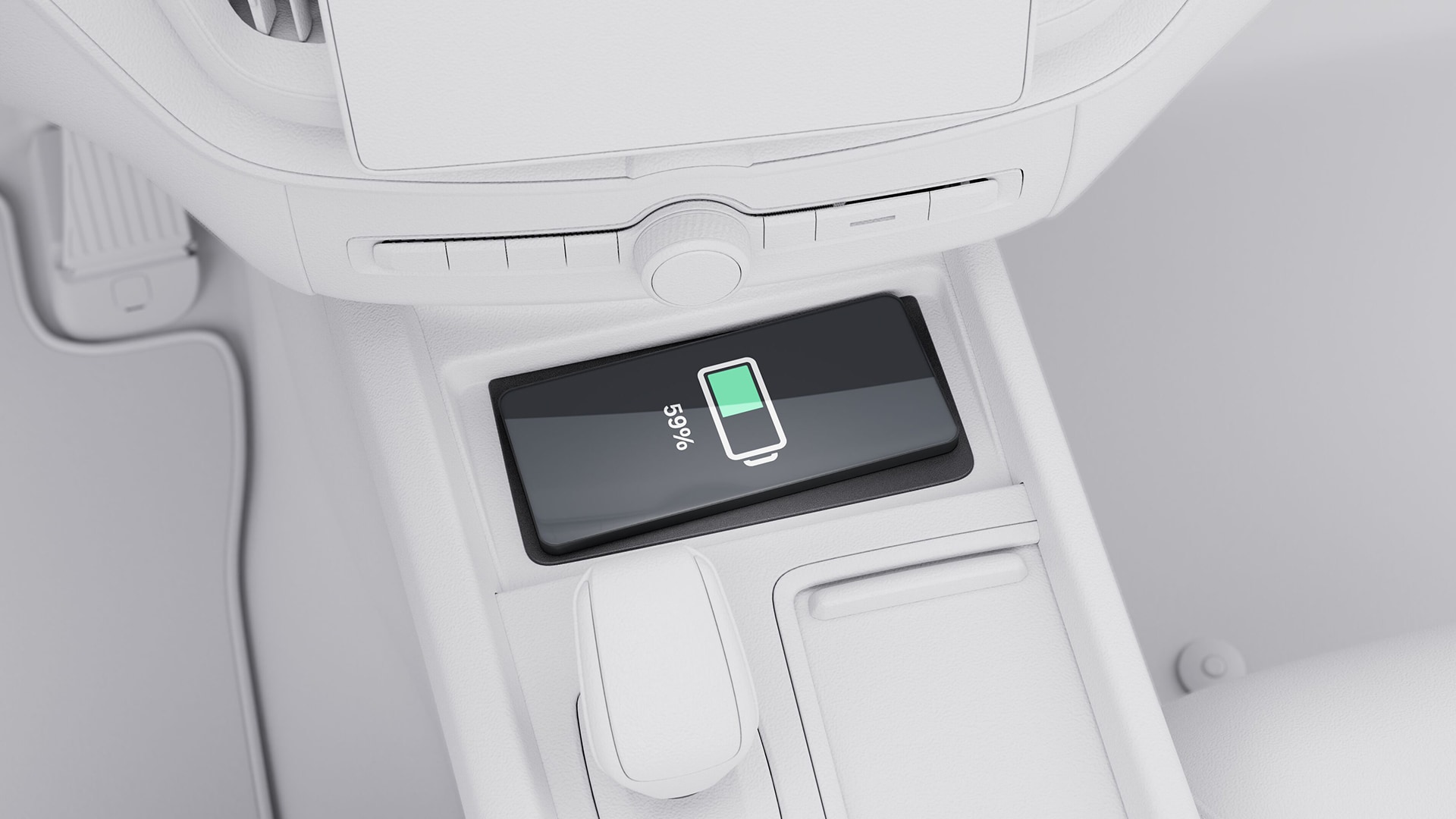 Ein Smartphone, das kabellos auf der Mittelkonsole eines Volvo aufgeladen wird und einen Batteriestand von 59 % anzeigt.