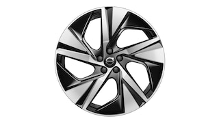 Volvo alloy wheel with a five-spoke, black and silver geometric design.